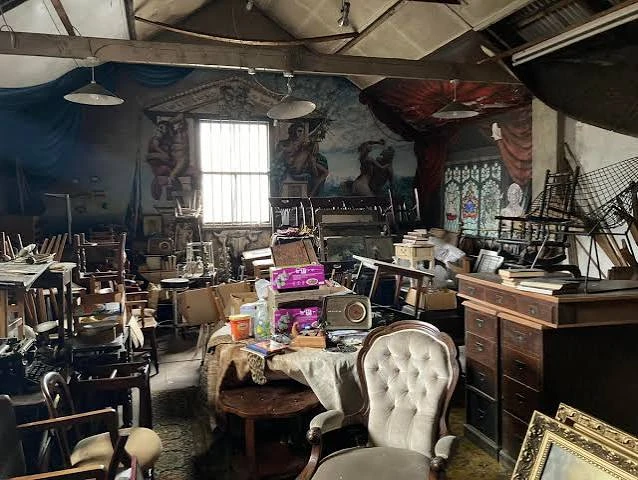 Inside the warehouse, packed floor to ceiling with furniture and curiosities