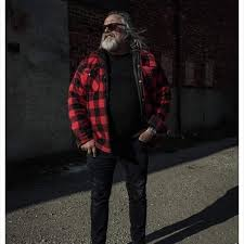 Kevin Marshall, standing outside in a red plaid jacket